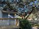View of house exterior with deck and large tree at 6790 Bass Hwy, St Cloud, FL 34771