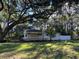 House exterior view with large tree and grassy yard at 6790 Bass Hwy, St Cloud, FL 34771