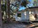 Side view of a house showcasing a small deck and window at 6790 Bass Hwy, St Cloud, FL 34771