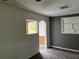 Open living room with sunroom access and built-in shelving at 6790 Bass Hwy, St Cloud, FL 34771