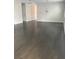 Spacious living room featuring hardwood floors and a modern chandelier at 15231 Honeybell Dr, Winter Garden, FL 34787