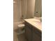 Clean bathroom with a tub, toilet and gray vanity at 15231 Honeybell Dr, Winter Garden, FL 34787