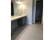 Modern bathroom with double vanity, gray cabinets, and tile flooring at 15231 Honeybell Dr, Winter Garden, FL 34787