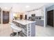 Open kitchen features an island, stainless steel appliances, and white and gray cabinets at 905 Knollwood Dr, Davenport, FL 33837