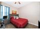 Bedroom with a red bed, nightstand, and ceiling fan at 905 Knollwood Dr, Davenport, FL 33837