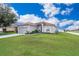 One-story house with gray siding, attached garage, and a spacious lawn at 905 Knollwood Dr, Davenport, FL 33837