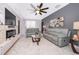 Relaxing living room with fireplace and ample natural light at 905 Knollwood Dr, Davenport, FL 33837