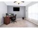 Home office with a large desk, computer, and neutral color scheme at 905 Knollwood Dr, Davenport, FL 33837