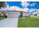 One-story house with gray siding, attached garage, and well-manicured lawn at 905 Knollwood Dr, Davenport, FL 33837