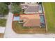 House with brown roof, fenced backyard and pool, aerial view at 905 Knollwood Dr, Davenport, FL 33837