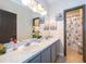 Bathroom with double vanity, gray cabinets, and a shower/tub combo at 905 Knollwood Dr, Davenport, FL 33837