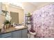 Bathroom with vanity, gray cabinets, and floral shower curtain at 905 Knollwood Dr, Davenport, FL 33837