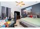 Bedroom with a green bed, workspace, and large TV at 905 Knollwood Dr, Davenport, FL 33837