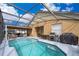 Enjoy this large screened-in pool and patio area at 905 Knollwood Dr, Davenport, FL 33837