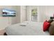 Comfortable bedroom with a king-size bed and a large TV at 8968 Silver Pl, Kissimmee, FL 34747
