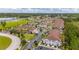Aerial view of townhouses, roads, and surrounding landscape at 8968 Silver Pl, Kissimmee, FL 34747