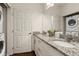 Modern bathroom with granite countertops, double sinks and laundry at 8968 Silver Pl, Kissimmee, FL 34747