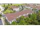 Aerial view of townhouse building, showcasing roofline and landscaping at 8968 Silver Pl, Kissimmee, FL 34747