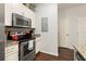 Modern kitchen with stainless steel appliances and white cabinets at 8968 Silver Pl, Kissimmee, FL 34747
