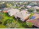 Aerial view of a residential neighborhood with houses, landscaping, and a lake at 227 Verona Dr, Poinciana, FL 34759