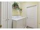 Bright laundry room with washer, dryer, and built-in shelving at 227 Verona Dr, Poinciana, FL 34759