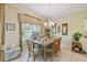 Bright dining area with a wooden table and access to a screened patio at 227 Verona Dr, Poinciana, FL 34759