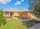 One-story house with a tan facade, landscaped yard, and attached garage at 227 Verona Dr, Poinciana, FL 34759