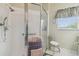 Bathroom with shower stall, toilet, vanity, and window at 227 Verona Dr, Poinciana, FL 34759
