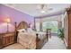 Serene bedroom with lavender walls, a comfortable bed, and ample closet space at 227 Verona Dr, Poinciana, FL 34759