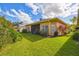 Landscaped backyard with lush greenery at 227 Verona Dr, Poinciana, FL 34759