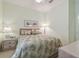 Bright bedroom with queen bed and ceiling fan at 227 Verona Dr, Poinciana, FL 34759