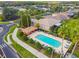 Community pool area with a cabana and surrounding palm trees at 227 Verona Dr, Poinciana, FL 34759