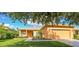 Charming one-story house with a covered porch and well-manicured lawn at 227 Verona Dr, Poinciana, FL 34759
