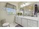 Clean bathroom with white vanity, a large mirror, and a walk-in shower at 227 Verona Dr, Poinciana, FL 34759