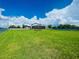 Spacious grassy backyard with a view of the house at 1980 Poblado Ct, Kissimmee, FL 34744