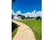 Landscaped front yard with a walkway to the entrance at 1980 Poblado Ct, Kissimmee, FL 34744