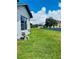 Landscaped backyard with green grass and pool pump at 1980 Poblado Ct, Kissimmee, FL 34744