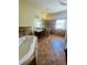 Elegant bathroom with a walk-in shower, soaking tub, and updated vanity at 1980 Poblado Ct, Kissimmee, FL 34744
