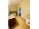 Bathroom with corner bathtub, granite vanity and toilet at 1980 Poblado Ct, Kissimmee, FL 34744