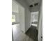 Long hallway with gray vinyl flooring and access to bedrooms at 1339 Tallahassee Ct, Kissimmee, FL 34759
