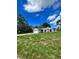 Newly built home with gray siding and a large yard at 1339 Tallahassee Ct, Kissimmee, FL 34759