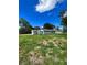 New construction home with gray siding, large yard, and side view at 1339 Tallahassee Ct, Kissimmee, FL 34759