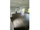 Open living room with kitchen island and vinyl plank flooring at 1339 Tallahassee Ct, Kissimmee, FL 34759