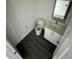 Clean bathroom with toilet, sink, and grey flooring at 1339 Tallahassee Ct, Kissimmee, FL 34759