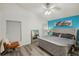 King-size bed, tufted headboard, and an accent wall at 2771 Cedaridge Cir, Clermont, FL 34711
