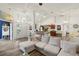Open living room with a large sectional sofa and kitchen island view at 2771 Cedaridge Cir, Clermont, FL 34711