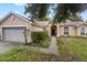 Two-car garage and front entrance of charming house at 2771 Cedaridge Cir, Clermont, FL 34711