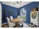 Charming dining area with a round table and four chairs, built-in wine rack at 2771 Cedaridge Cir, Clermont, FL 34711