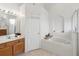 Bathroom with soaking tub, double vanity, and separate shower at 2771 Cedaridge Cir, Clermont, FL 34711