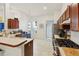 Modern kitchen with wood cabinets, stainless steel appliances, and an island at 2771 Cedaridge Cir, Clermont, FL 34711